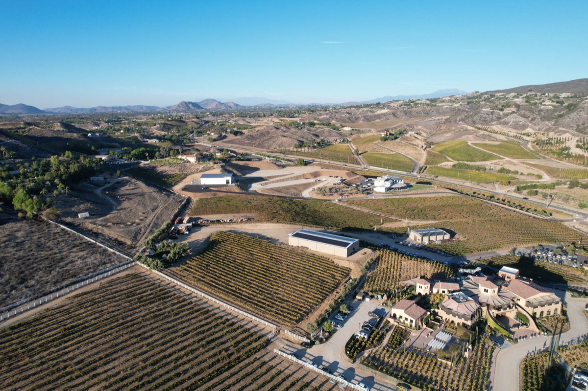 Napa Valley winery with stone facade and vineyard backdrop