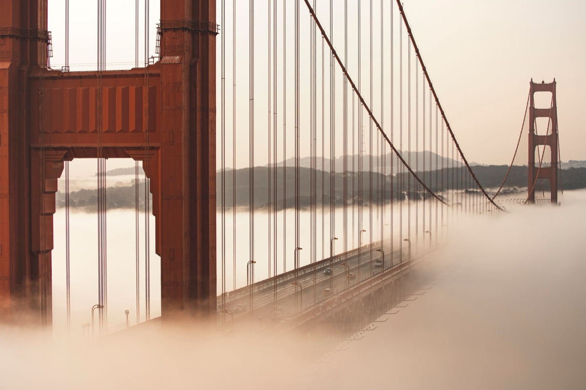 Golden Gate Bridge at dawn with fog and foggy sky