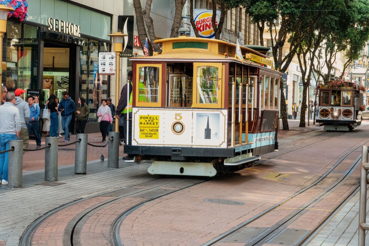 San Francisco cable cars at street level with fog and foggy sky