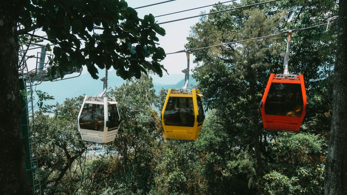 Cable car station view with waiting passengers and informational board