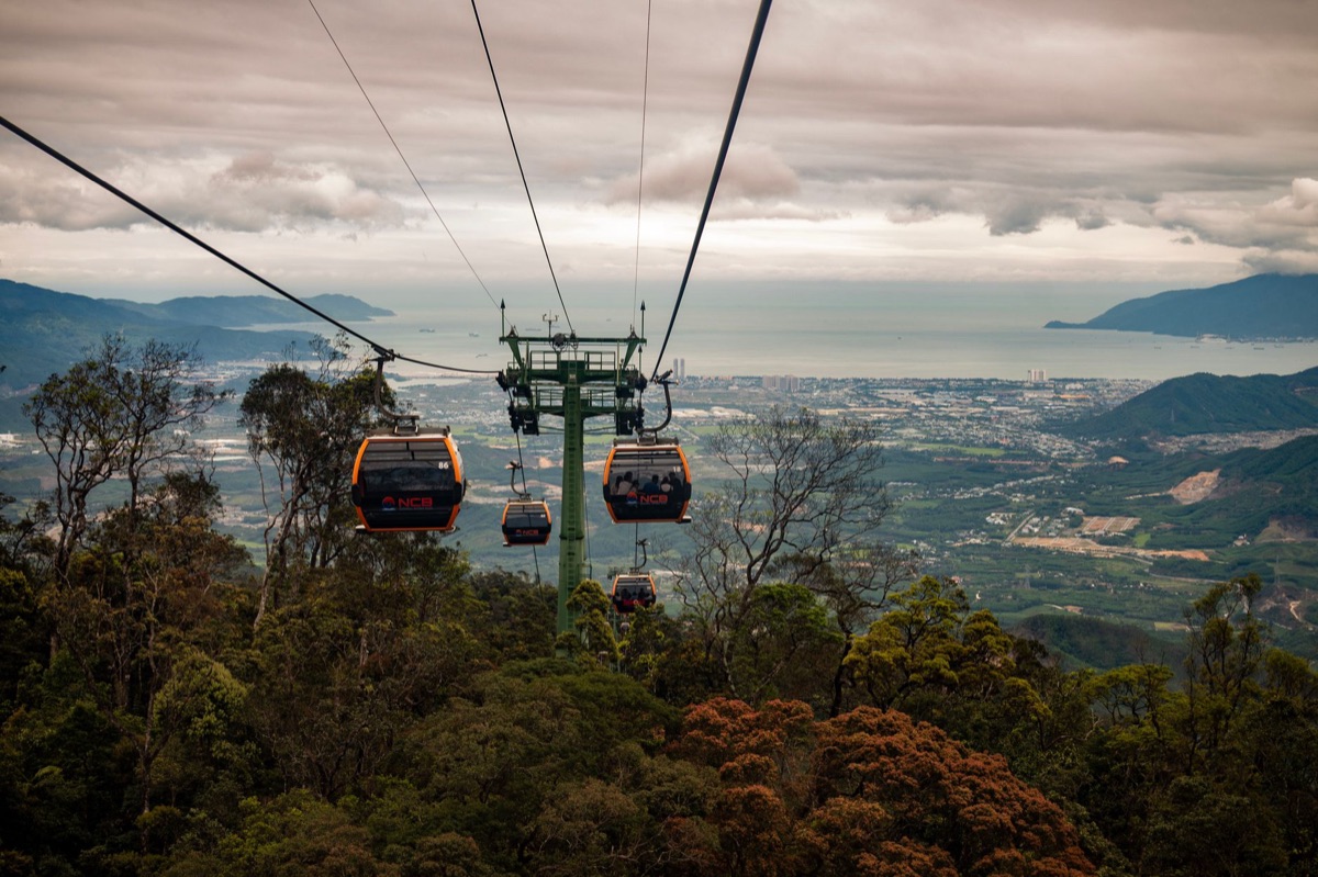 Cable car station with informational signs and waiting passengers