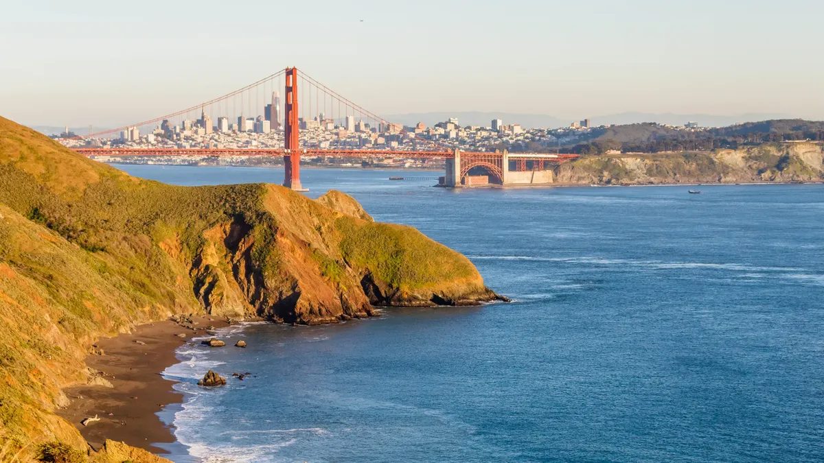 Stunning aerial view of the Golden Gate Bridge over San Francisco Bay with a clear sky.